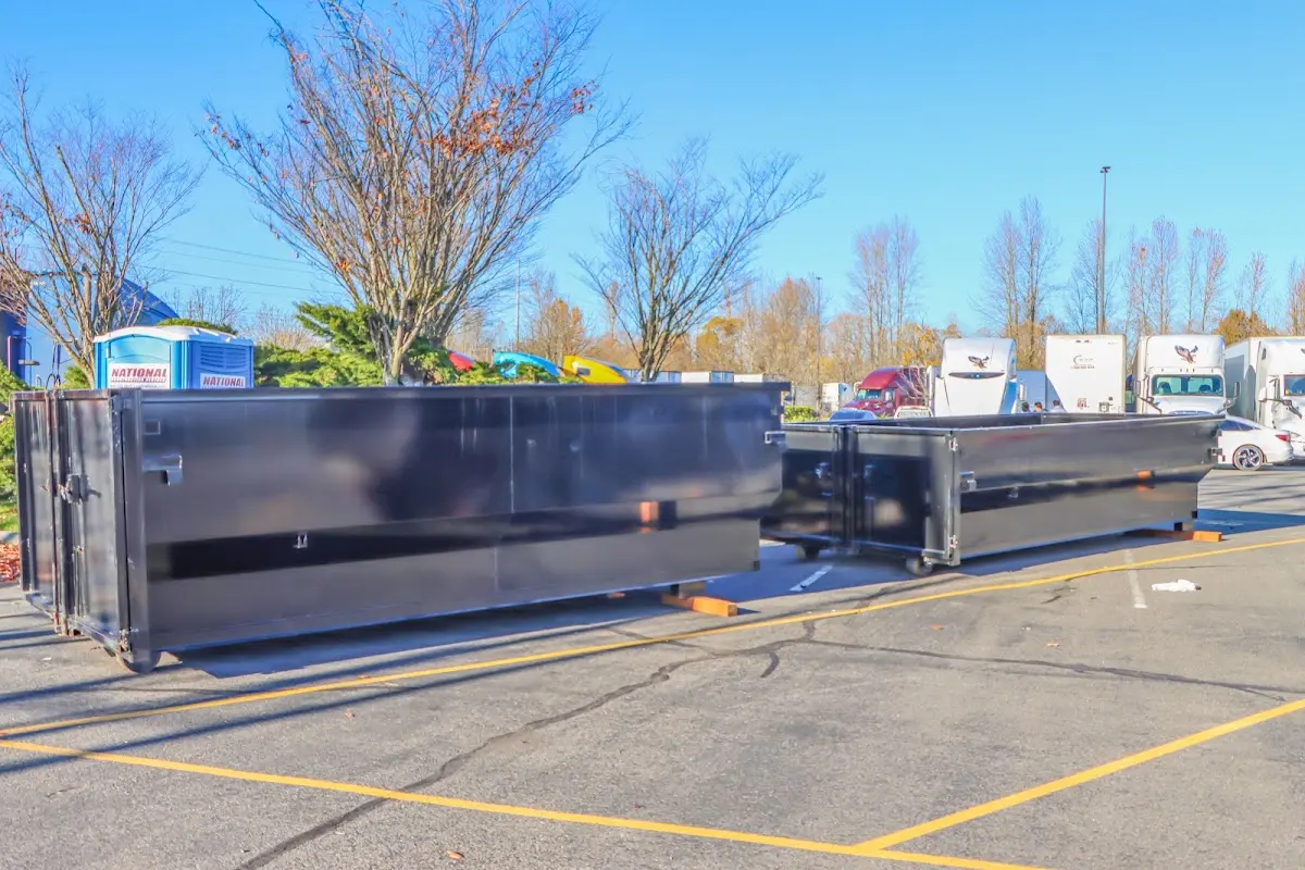 Professional dumpster rental service with roll-off container on residential driveway in Northridge